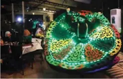  ??  ?? DAMASCUS: A Syrian whirling dervish performs during the holy month of Ramadan at a cafe in the Syrian capital early yesterday. — AFP