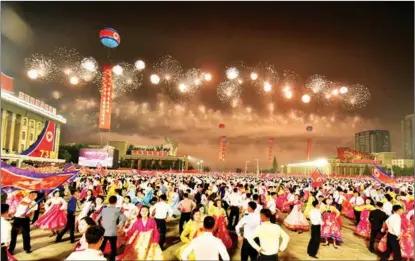  ?? AFP ?? People dance in Kim Il-sung Square in Pyongyang, Democratic People’s Republic of Korea, on Sept 9, to celebrate the 73rd anniversar­y of the founding of the DPRK.