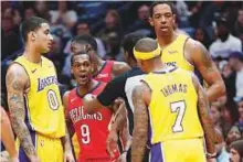  ?? AP ?? New Orleans Pelicans guard Rajon Rondo (9) and Los Angeles Lakers guard Isaiah Thomas (7) are separated by an official during the first half of an NBA game.