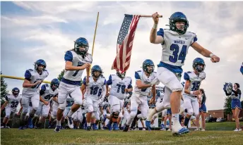  ?? ?? Waverly Central High School’s Kade Anderson (34) leads his team onto the field before a game against Sycamore at Sycamore High School in Pleasant View, Tenn., on Friday, September 3, 2021. The game was the team’s first since severe storms and extreme flash floods killed 20 people and left more than 200 families homeless in the Waverly area. Andrew Nelles / The Tennessean