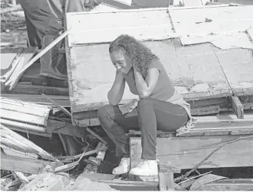  ?? Rogelio V. Solis / Associated Press ?? Shanise McMorris contemplat­es what’s next for her family as she sits on the slab of her Hattiesbur­g, Miss., home after a tornado and heavy rain tore through the city and nearby counties Saturday morning.