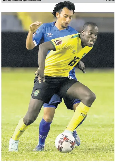  ?? AP ?? Jamaica’s Je-Vaughn Watson (front) dribbles the ball while challenged by El Salvador’s Bryan Landaverde during a qualifying match for the FIFA World Cup Qatar 2022 at Cuscatlan stadium in San Salvador, El Salvador, on Friday.