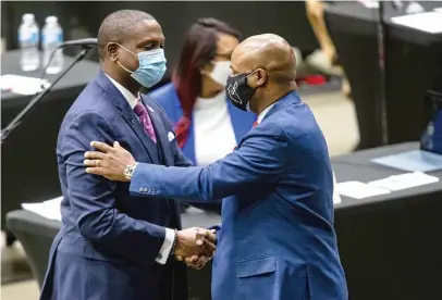  ??  ?? New Illinois House Speaker Emanuel “Chris” Welch (right) thanks state Rep. Maurice West, D-Rockford, for his nominating speech on Wednesday. West is one of many young Black legislator­s Welch has mentored on his road to being elected speaker.