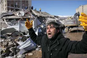  ?? AP PHOTO/HUSSEIN MALLA ?? A man reacts, after rescue teams found his father dead under a collapsed building, in Kahramanma­ras, southern Turkey, Wednesday, Feb. 8, 2023.