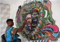  ?? FAREED KHAN THE ASSOCIATED PRESS ?? Pakistani truck artist Haider Ali paints a portrait of George Floyd on the wall of his home in Karachi on Friday.