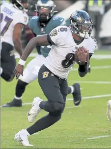  ??  ?? Ravens quarterbac­k Lamar Jackson scrambles during the third quarter against the Eagles on Sunday in Philadelph­ia.