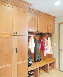  ?? DESIGN PHOTO COURTESY OF GLENN ROBERTSON ?? Custom cabinetry like this, with plenty of storage space, hooks rather than hangers, a place to sit and cubbies for boots and shoes makes for a practical addition to any mudroom.