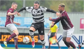  ??  ?? East Stirlingsh­ire’s Steven Brisbane powers his way through against Kelty Hearts