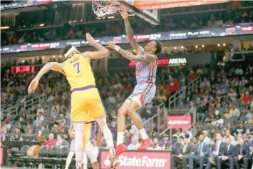  ??  ?? Atlanta Hawks’ John Collins (20) dunks against the Los Angeles Lakers at State Farm Arena. — USA Today Sports