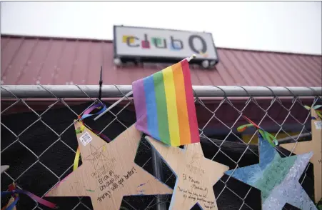  ?? DAVID ZALUBOWSKI — THE ASSOCIATED PRESS ?? Tributes hang on a fence outside of Club Q on Wednesday in Colorado Springs. A Navy sailor grabbed the barrel of a gunman’s rifle and an Army veteran rushed in to help as they ended the deadly mass shooting at the gay nightclub in November, a police detective testified Wednesday.