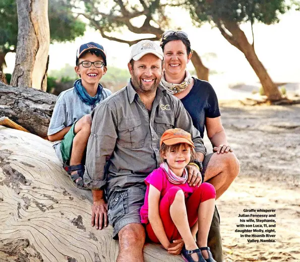  ??  ?? Giraffe whisperer Julian Fennessy and his wife, Stephanie, with son Luca, 11, and daughter Molly, eight, in the Hoanib River Valley, Nambia.