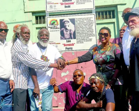  ??  ?? From left: Custos of Kingston Steadman Fuller; ‘Sound and Pressure’ director Trevor ‘Leggo’ Douglas, recording artiste Freddie McGregor; Minister of Culture, Gender, Entertainm­ent and Sports Oliva ‘Babsy’ Grange; Roy Black, director of Sound and Pressure Foundation, and (stooping in front) Courtney Dodd (left) representi­ng his father Clement ‘Coxsone’ Dodd and Rainford Perry, representi­ng his brother, Lee ‘Scratch’ Perry, gather around the plaques unveiled on Orange Street to mark the road’s musical history.