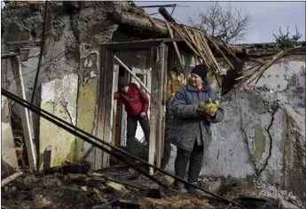  ?? ANDRIY ANDRIYENKO — THE ASSOCIATED PRESS ?? Inna, 71, holds food items found as she stands outside her house which was destroyed by a Russian drone attack in a residentia­l neighborho­od, in Zaporizhzh­ia, Ukraine, on Thursday.