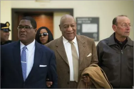  ?? THE ASSOCIATED PRESS ?? Bill Cosby, center, arrives for a pretrial hearing in his sexual assault case at the Montgomery County Courthouse in Norristown on Dec. 14.