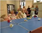  ??  ?? Tackling isolation Sandra, back left, is supported by a number of volunteers and hosts tea parties and days out for over 75s living in Rutherglen and Cambuslang