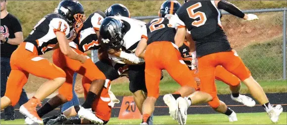  ?? Westside Eagle Observer/MIKE ECKELS ?? A pride of Lions surround Blackhawk quarterbac­k Tate Busey near the 20-yard line of Gravette shortly after the start of the Oct. 5 Gravette-Pea Ridge football contest at Lions Stadium in Gravette.