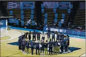  ?? Source: ROBERT FRANKLIN — THE ASSOCIATED PRESS ?? Oral Roberts players and coaches form a prayer circle on the court following their win over Ohio State in a firstround game in the NCAA tournament Friday at Mackey Arena in West Lafayette, Ind.