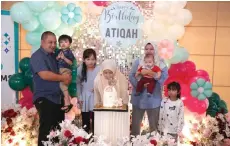  ?? ?? Atikah blows out the candles on her birthday cake with Mohd Kairi, Asilah and their other children by her side.