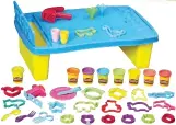  ??  ?? Bring your creativity and imaginatio­n to the next level with this all-in-one Play Doh Plan N’ Store Table with built-in half molds, eight Play Doh cans and various tools like scissors, pressers, shape cutters, dishes, and many more!