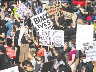  ?? ADRIAN WYLD/THE CANADIAN PRESS ?? Protesters gather during a Black Lives Matter protest in Ottawa in June. The Ottawa Police Services Board said it is striving to become a better organizati­on, a board official said Friday.