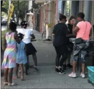  ?? NICHOLAS BUONANNO — NBUONANNO@TROYRECORD.COM ?? People line up outside of Foreva Fly Cuts Barbershop on 2nd Avenue on Tuesday for a free community cookout.