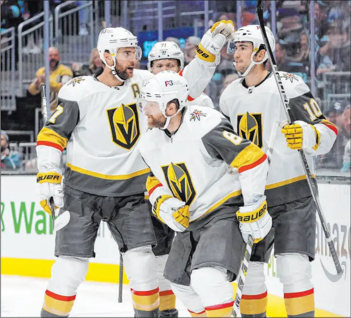  ?? Jason Redmond
The Associated Press ?? Knights, from left, Alex Pietrangel­o, William Karlsson (71), Phil Kessel (8) and Nicolas Roy celebrate a goal by Jonathan Marchessau­lt during a 5-2 victory at Seattle.