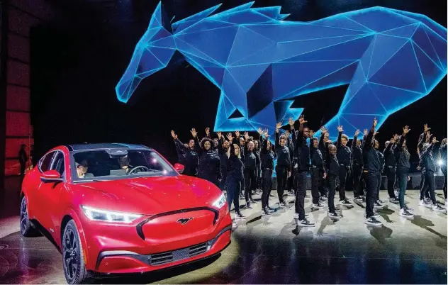  ?? Agence France-presse ?? ↑ Ford’s first mass-market electric car Mustang Mach-e on display on Wednesday following the company’s announceme­nt to build electric cars in Cologne, Germany.
