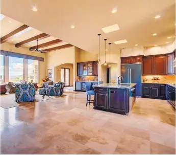  ??  ?? An open floor plan connects the living room, kitchen and dining nook in the 3,886-square-foot New Haven Homes entry.