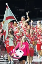  ??  ?? Flag bearer: Dan Halksworth with the Jersey team at the opening ceremony