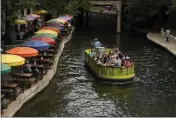  ?? ERIC GAY — THE ASSOCIATED PRESS ?? A barge tours along the Riverwalk in San Antonio.