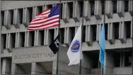  ?? (AP/Charles Krupa) ?? The American flag, the Commonweal­th of Massachuse­tts flag and the City of Boston flag (from left) fly outside Boston City Hall on Monday in Boston.