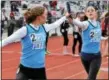  ?? DIGITAL FIRST MEDIA FILE PHOTO ?? North Penn’s Phoebe Clowser takes the baton from Mikaela Vlasic competing in the 4x800 relay event during the Pennsylvan­ia Track Classic at Plymouth Whitemarsh High School on Saturday. March 28,2015.