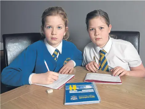  ?? Picture: Tina Norris. ?? Kayleigh Roy and Lexi Cruickshan­k, pupils at Limekilns Primary, are two of five children in their class of 12 who have been told they are outside the catchment area for Woodmill High School.