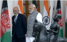  ?? — SONDEEP SHANKAR ?? Prime Minister Narendra Modi (right) and Afghanista­n President Mohammad Ashraf Ghani arrive for talks in New Delhi on Tuesday.