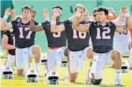  ?? AL DIAZ/AP ?? Quarterbac­k Malik Rosier (12) and fellow quarterbac­ks stretch during football practice at the University of Miami on Wednesday. Rosier says former players have contacted him with congratula­tions for earning the starting job.