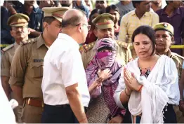  ??  ?? Officials with the wife of Apple executive Vivek Tiwari who was shot dead by cops.