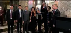  ?? RUINAN / CHINA DAILY ZHANG ?? Zhang Qiyue (center, left), Chinese consul general in New York, and Anthony Malkin (center, right), CEO of Empire State Realty Trust, flip the switch in a lighting ceremony with representa­tives of local Chinese communitie­s on Tuesday at the Empire...