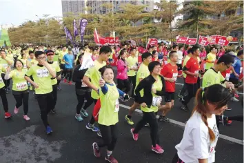  ??  ?? XIAMEN, China: This photo taken on Dec 10, 2016 shows runners taking part in the half marathon in eastern China’s Fujian province. — AFP