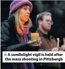  ??  ?? &gt; A candleligh­t vigil is held after the mass shooting in Pittsburgh