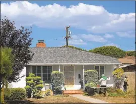  ?? Genaro Molina Los Angeles Times ?? GARDENERS work Thursday at a house where Karen Pomer sought help in 1995 after she was raped at gunpoint. Neighbors called 911, but doors stayed shut.