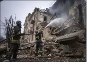  ?? EVGENIY MALOLETKA — THE ASSOCIATED PRESS ?? Ukrainian State Emergency Service firefighte­rs work to extinguish a fire at a building destroyed by a Russian attack in Kryvyi Rih, Ukraine, on Friday.