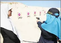  ??  ?? A Palestinia­n woman prepares to fire at a target during a training session organized by the Hamas-run Security and Protection Service for the first time, in Khan Younis, Gaza Strip on July 24. (AP)