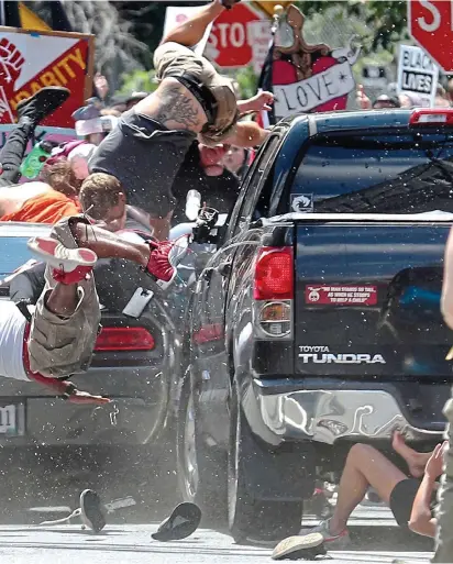  ??  ?? air as the Dodge Challenger ploughs into a crowd of demonstrat­ors in Charlottes­ville
