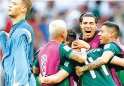  ?? (AP) ?? Germany goalkeeper Manuel Neuer walks past as Mexico players celebrate after defeating Germany 1-0 in their group F match at the 2018 soccer World Cup in the Luzhniki Stadium in Moscow, Russia Sunday.