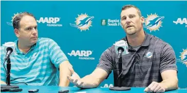  ?? SUSAN STOCKER/STAFF PHOTOGRAPH­ER ?? Dolphins VP Mike Tannenbaum, left, listens while interim head coach Dan Campbell speaks at a news conference Monday.