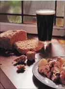  ?? SUSAN TUSA TNS ?? A glass of stout, bread and lamb stew. Guinness gives this stew its deep flavor.