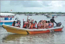  ?? XINHUA ?? Chinese tourists enjoy a boat ride at Benoa Bay in Bali, Indonesia, on Feb 13 last year.