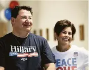  ??  ?? Hillary Clinton supporters James Perez and Cyndi Pena enjoyed speeches from local Democratic representa­tives and other officials at the event.