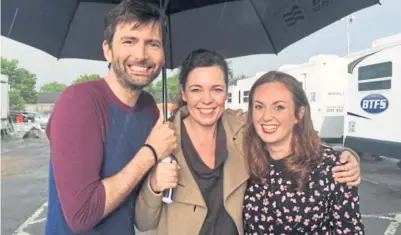  ?? ?? Martine, sorry Martel, sharing an umbrella with actors David Tennant and Olivia Colman.