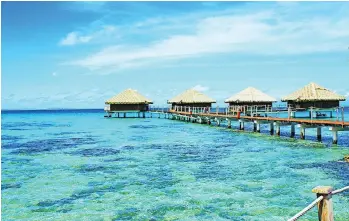  ??  ?? Bungalows over the aquamarine waters of Huahine are a tropical dream.